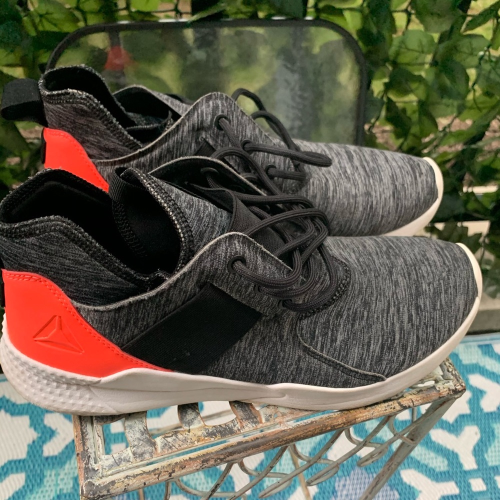 Reebok women’s sneaker in gray, orange and black